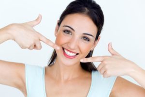 A woman satisfied with her teeth whitening treatment.